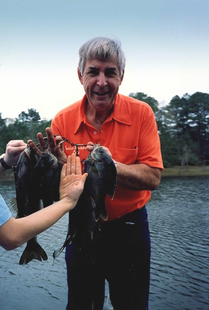 Dad holding a stringer of fish